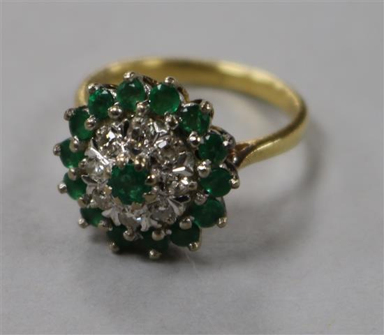 An 18ct gold, emerald and diamond cluster dress ring, size N.